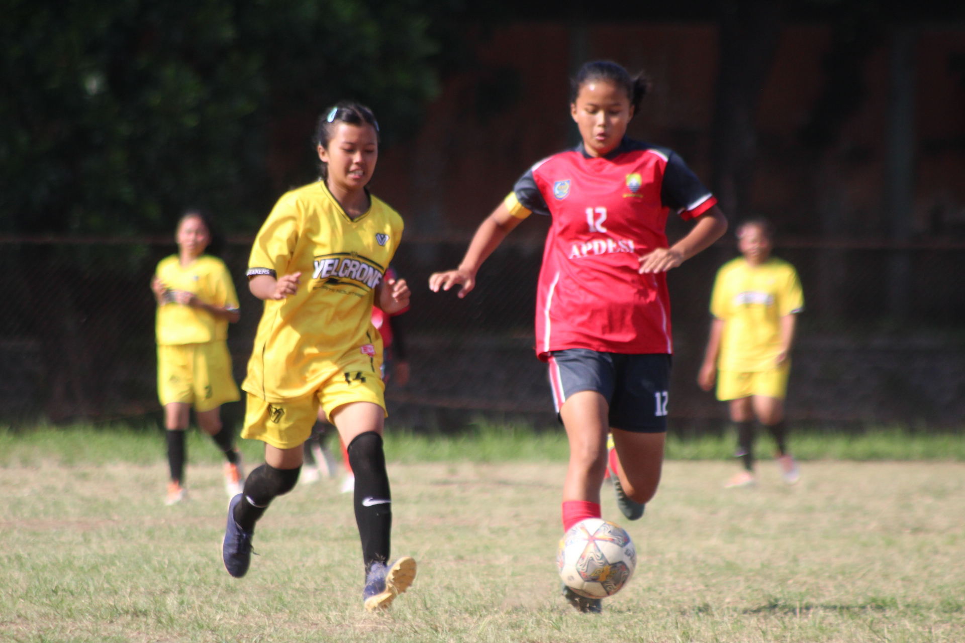 SEPAKBOLA WANITA: Kapten tim kecamatan Pamulihan Delia (baju merah) saat mengocek bola, dibayang-bayangi tim kecamatan Cisitu di Lapang Sepakbola Ahmad Yani (28/07).